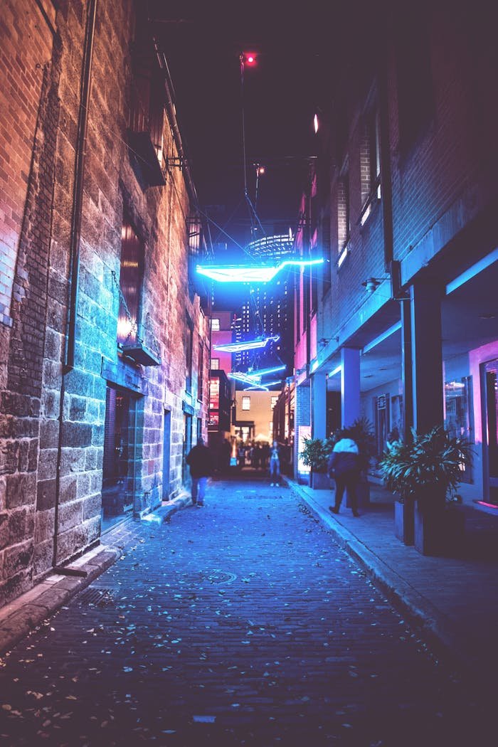 Explore the colorful nightlife of Sydney with this vibrant alley illuminated by neon lights.